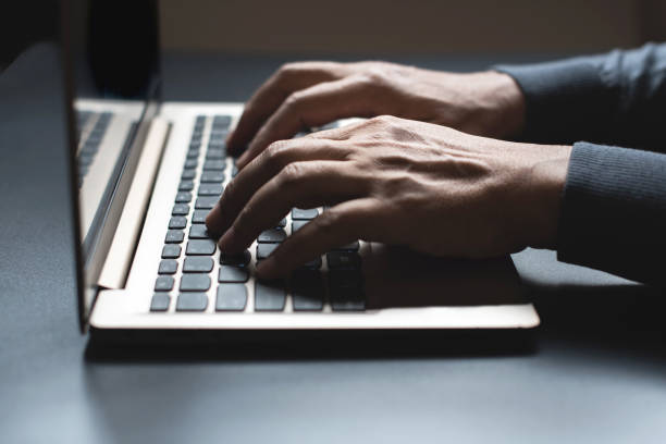 istock Close up of person hand typing on laptop keyboard, author useing internet on notebook computer 1320726380