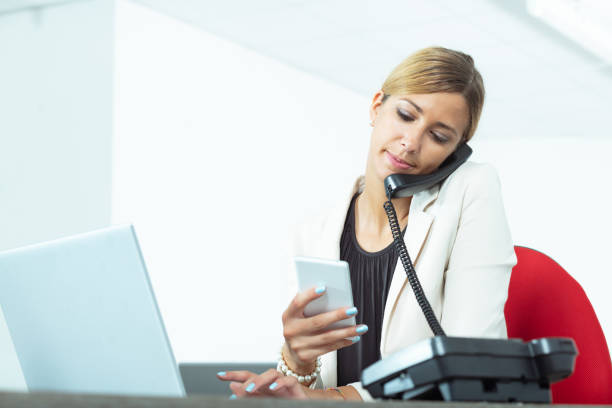 istock Businesswoman multitasking at her desk in the office 1320727452