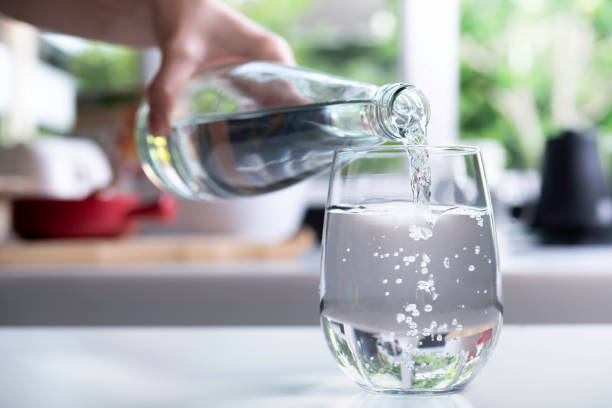 istock Pouring water into glass in the kitchen 1320728205