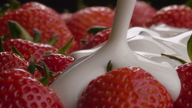 Yogurt pouring onto strawberries
