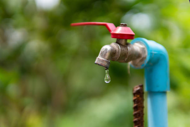 istock Water droplets dripping from the old faucet 1320733846
