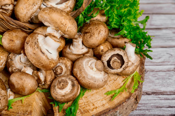 istock Portobello champignons on a wooden table. Close up. 1320735395