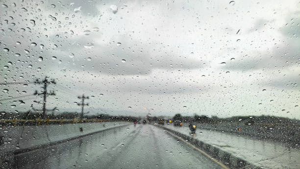 istock A car window with rain drops while on the road 1320736964