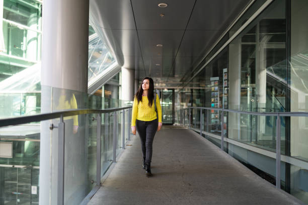 istock Young female student walking in mall. 1320737759