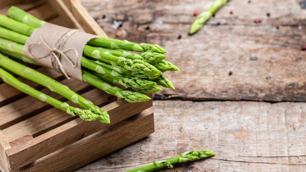istock Asparagus. Fresh green asparagus on a wooden background. Long banner format, top view 1320738863