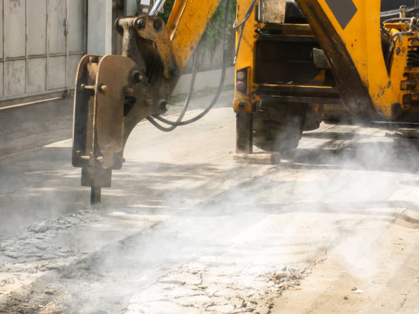istock Machine is working to drill the concrete pavement Causing dust smoke and noise pollution The operation of machine to drill the road surface 1320743295