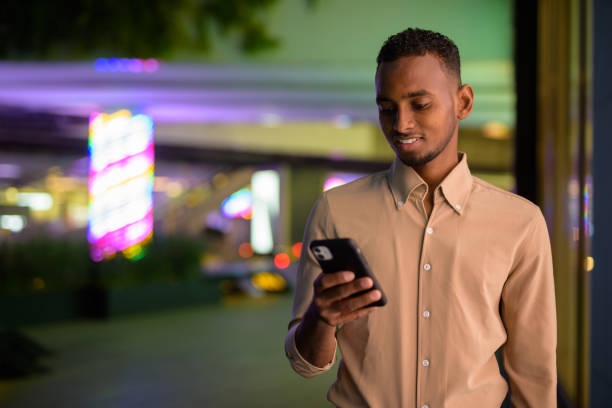 istock Black young African businessman outdoors in city using mobile phone 1320744843