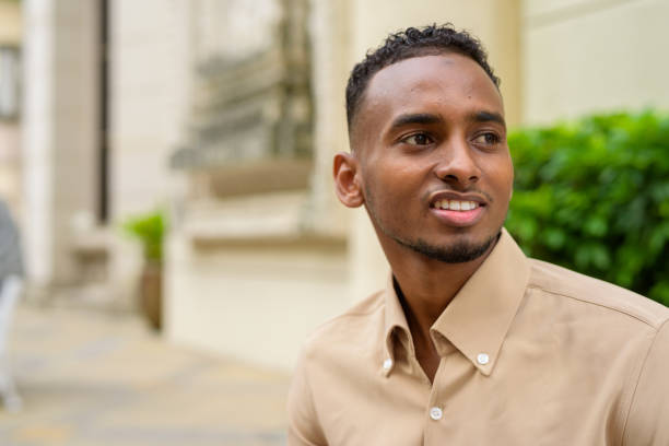 istock African businessman outdoors in city smiling and thinking 1320744857