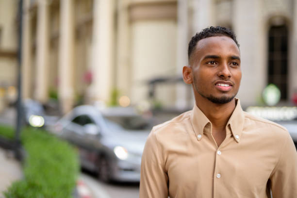 istock African businessman smiling and thinking outdoors in city 1320744962