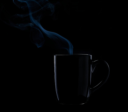 Black cup with smoke on black background