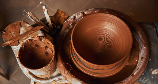 istock Image of fresh ceramic brown bowl in pottery workshop 1320746195