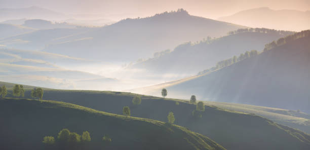istock Over the mountain valley, green hills and mist, morning 1320748052