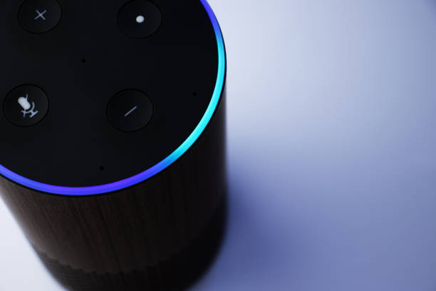 Close up of smart speaker assistant - personal assistant - blue light Close up of smart speaker assistant - personal assistant - blue light virtual assistant stock pictures, royalty-free photos & images
