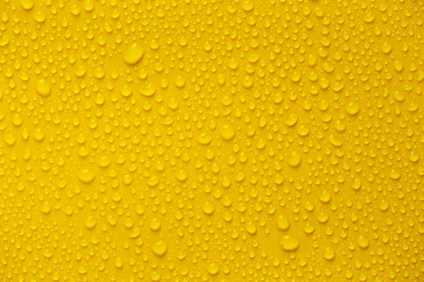 istock Rain or Water drops on yellow background 1320750244