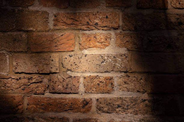 istock Old sandstone brick wall partly in shade 1320751520