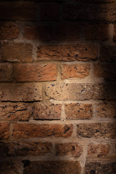 istock Old sandstone brick wall partly in shade 1320752577