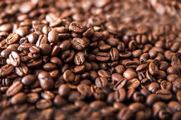 istock Coffee background close-up macro. Lots of coffee beans and copy space. 1320755459