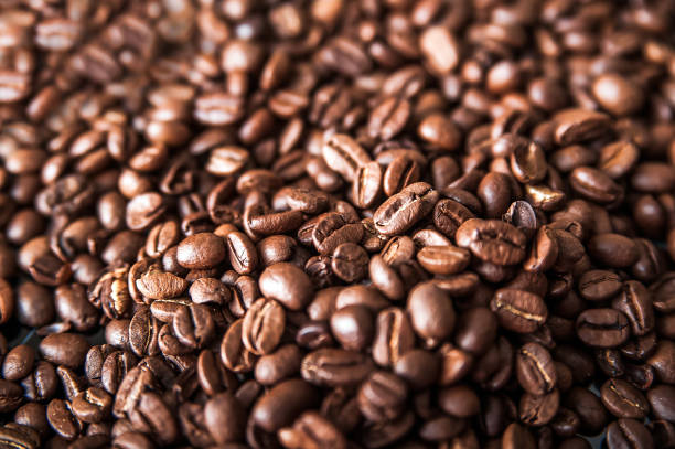 istock Coffee background close-up macro. Lots of coffee beans and copy space. 1320755466