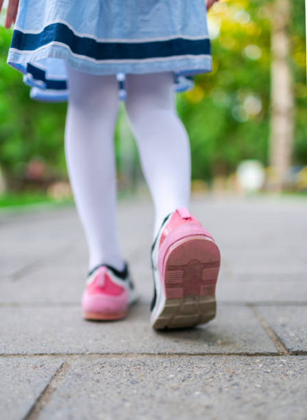 little girl walk in the road close-up - healthy lifestyle nature sports shoe childhood imagens e fotografias de stock