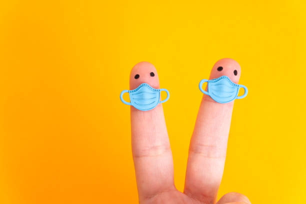 istock Two finger characters wearing face masks while keeping distance 1320755929