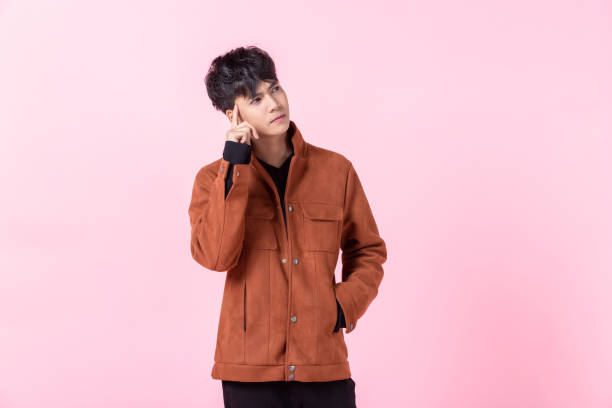 istock Asian a man handsome young thinking on something in love isolated on pink blank copy space studio background. 1320756816