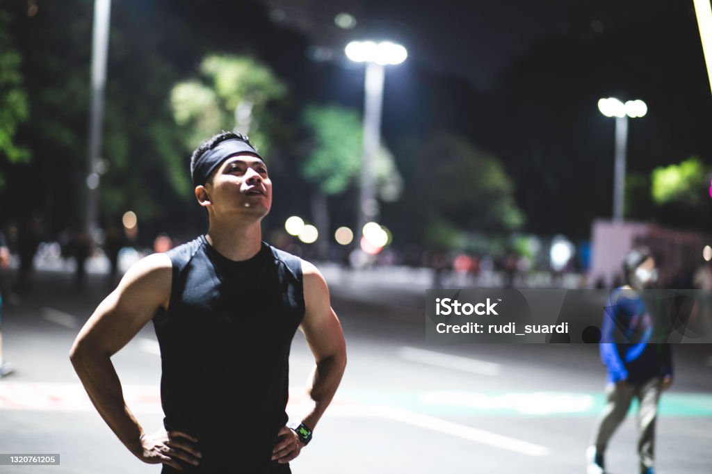 Night Running in Gelora Karno Jakarta asian young man night sport in Gelora Bung Karno Jakarta after office hour Active Lifestyle Stock Photo