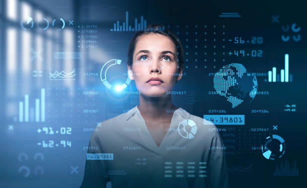 istock Young attractive businesswoman is looking at digital interface with diagrams 1320763924