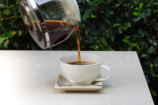 istock Pour coffee from the pot into a cup 1320764051