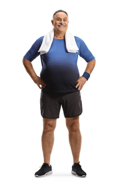 Full length portrait of a mature man in sportswear with a towel around his neck Full length portrait of a mature man in sportswear with a towel around his neck isolated on white background chubby arab stock pictures, royalty-free photos & images