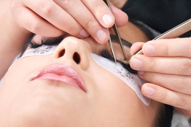 istock Eyelash Extension Procedure. Woman Eye with Long Eyelashes 1320774469