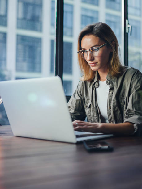 istock Woman working on laptop. Freelancer at remote work. Female student learning on-line via computer. Blogger or journalist writing new article. 1320775594