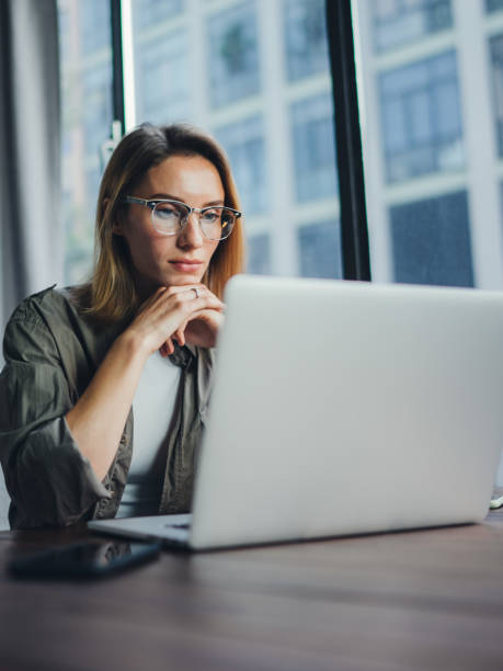 istock Woman working on laptop. Freelancer at remote work. Female student learning on-line via computer. Blogger or journalist writing new article. 1320775596