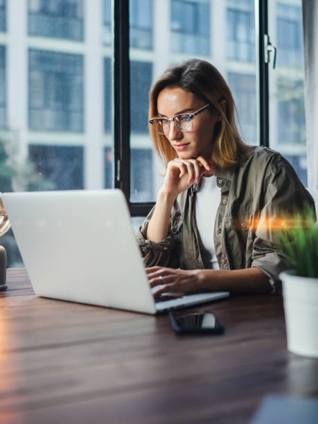 istock Woman working on laptop. Freelancer at remote work. Female student learning on-line via computer. Blogger or journalist writing new article. 1320775605