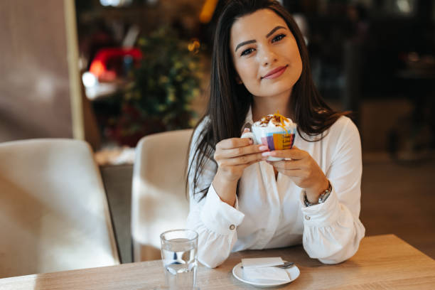 istock Young woman drinking coffee at the cafe 1320778239