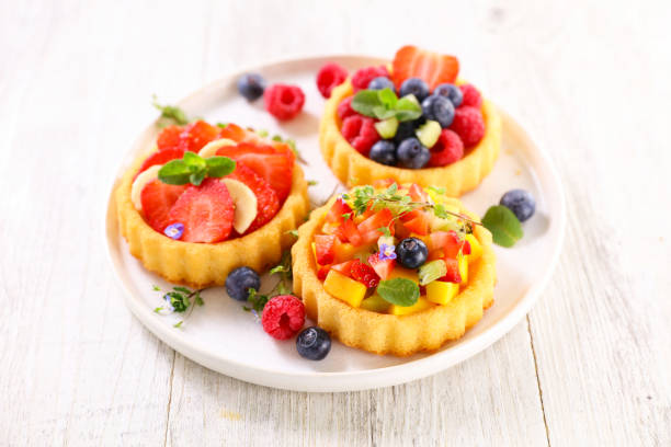 istock assorted of fresh fruit tart in plate 1320781422