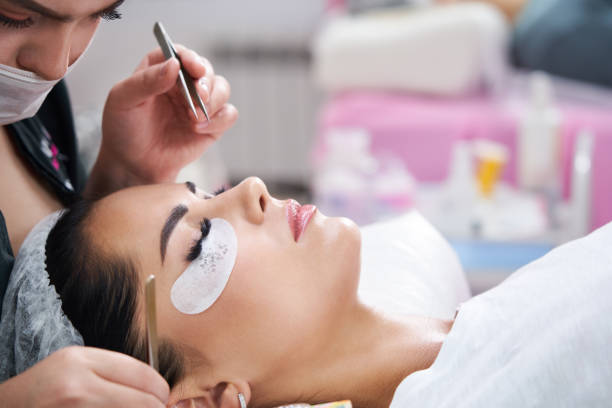istock Eyelash Extension Procedure. Woman Eye with Long Eyelashes 1320781515