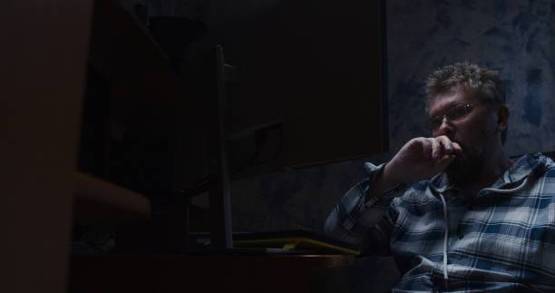 istock Mature man is working late at the desktop computer 1320782365