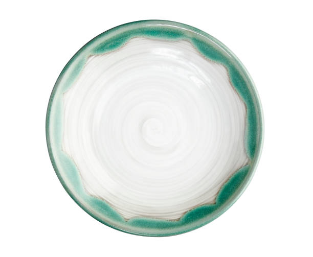 istock White ceramic plate with green edge, Empty plate with spiral pattern isolated on white background with clipping path, Top view 1320782389