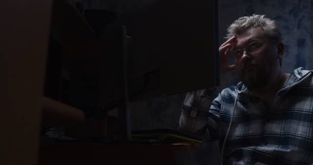 istock Mature man is working late at the desktop computer 1320782544