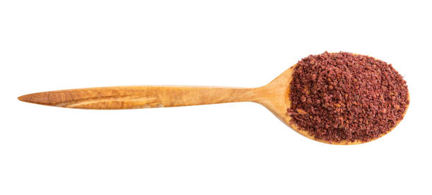 top view of wood spoon with ground sumac isolated top view of wood spoon with ground sumac isolated on white background sumac spice stock pictures, royalty-free photos & images