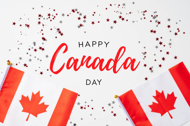 istock Happy Canada Day banner mockup. Canadian flags and confetti on white table. Flat lay, top view, copy space. 1320787563