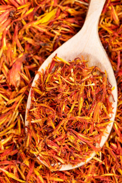 istock spoon with dried safflower petals close up on pile 1320787644