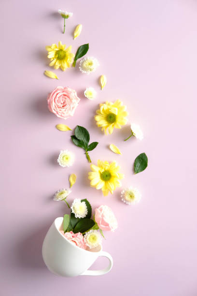 istock Creative composition with mug and flowers on pink background. Herbal tea concept. 1320787788