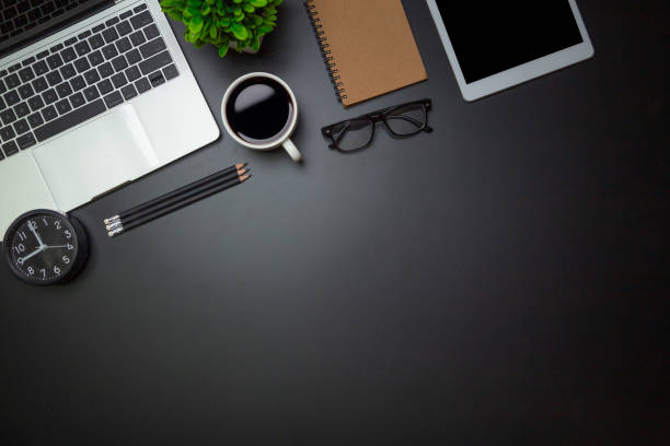istock Workspace - Flat top view illustration of a workspace with a coffee cup and notebook on the black desk surface,Office desk concept. 1320788141