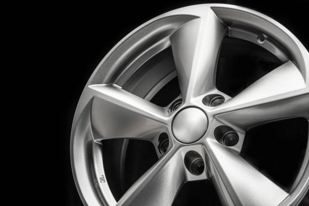 istock a gray shiny, silver alloy wheel on a black background. close-up 1320789868