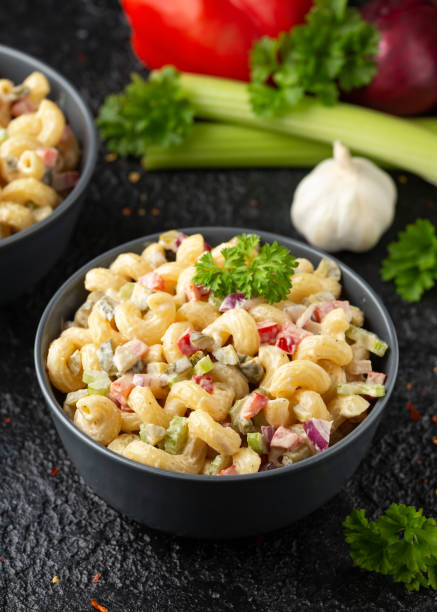 istock Macaroni Salad with red bell pepper, onion, celery, gherkins and mayonnaise dressing 1320791044