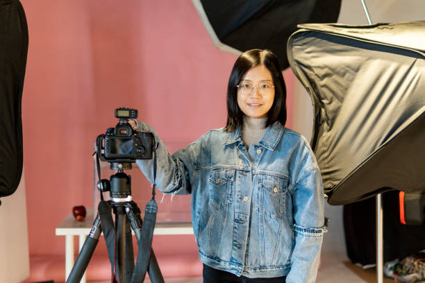 istock Asian female photographer in the studio 1320793331