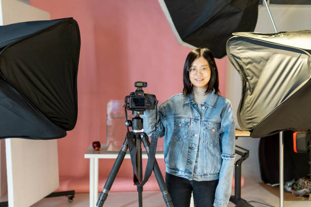 istock Asian female photographer in the studio 1320793336