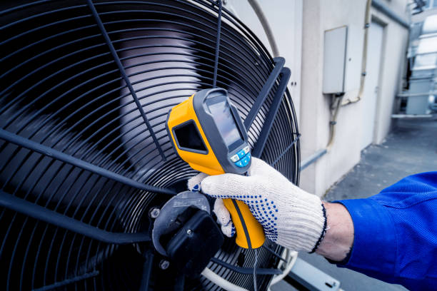 istock Technician uses a thermal imaging infrared thermometer to check the condensing unit heat exchanger. 1320793405