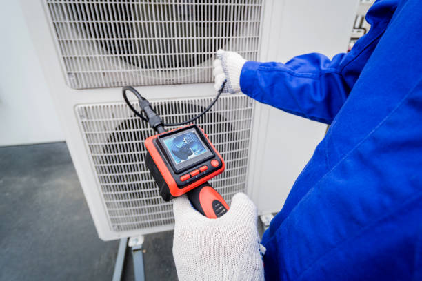 the technician uses a digital camera to check the clogging of the heat exchanger the technician uses a digital camera to check the clogging of the heat exchanger. Air Exchanger stock pictures, royalty-free photos & images